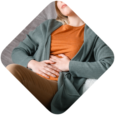 Upset female squeezing belly with hand because of abdominal pain.